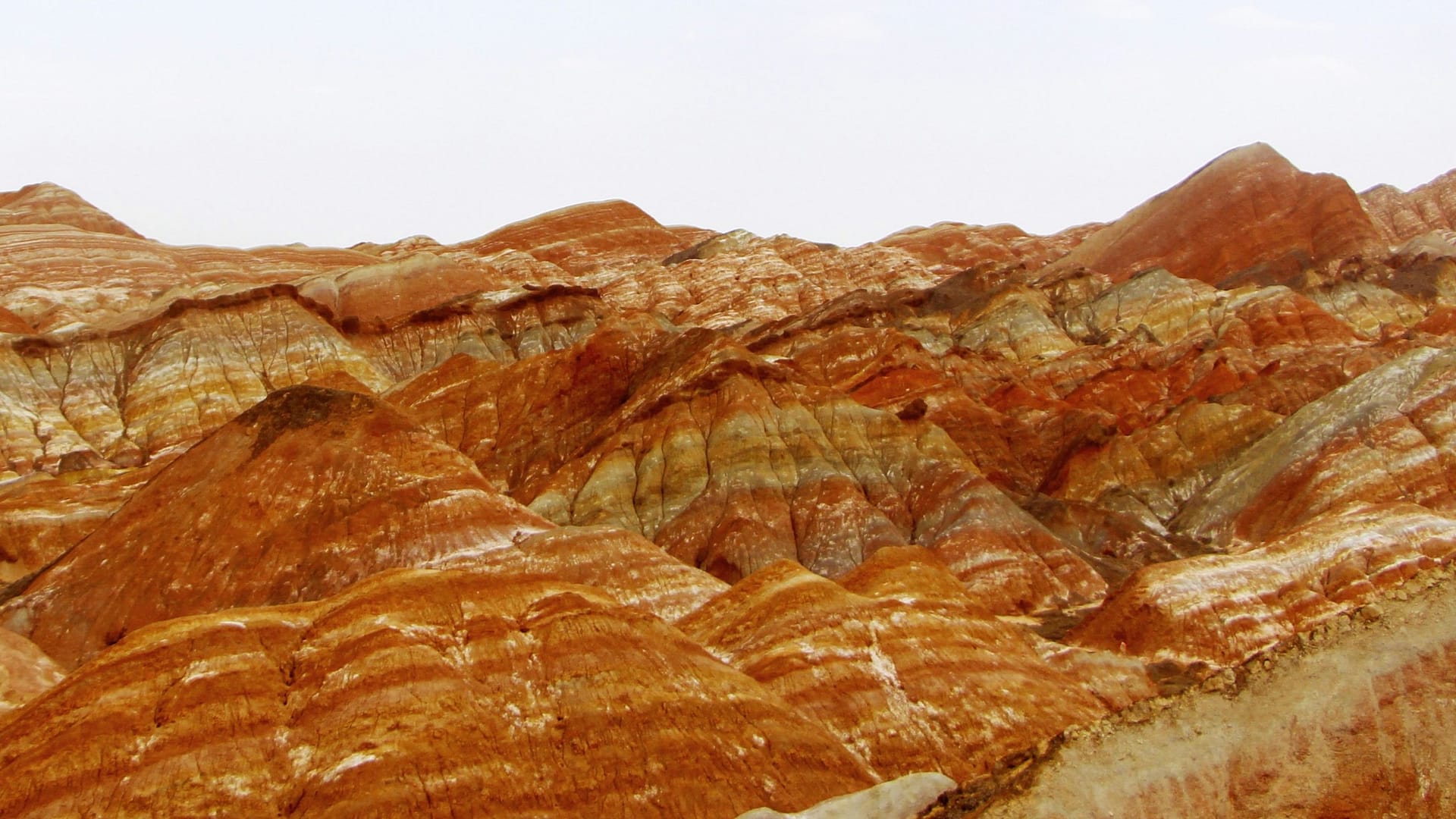 Zhangye Danxia rainbow mountains showing layered red, orange and yellow striated cliffs in Gansu, China