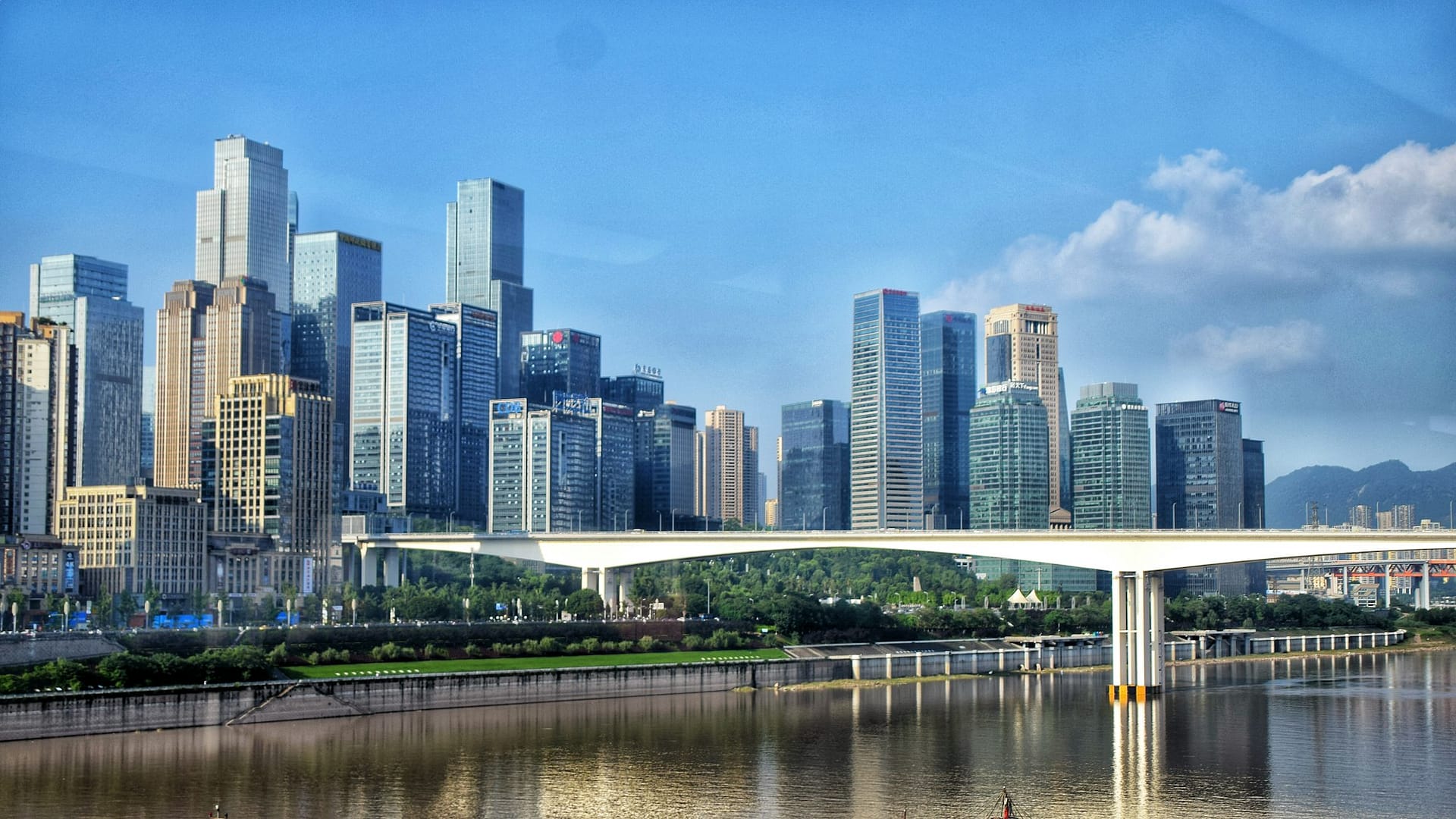 A bridge spanning the river between Chongqing’s high-rise districts by day